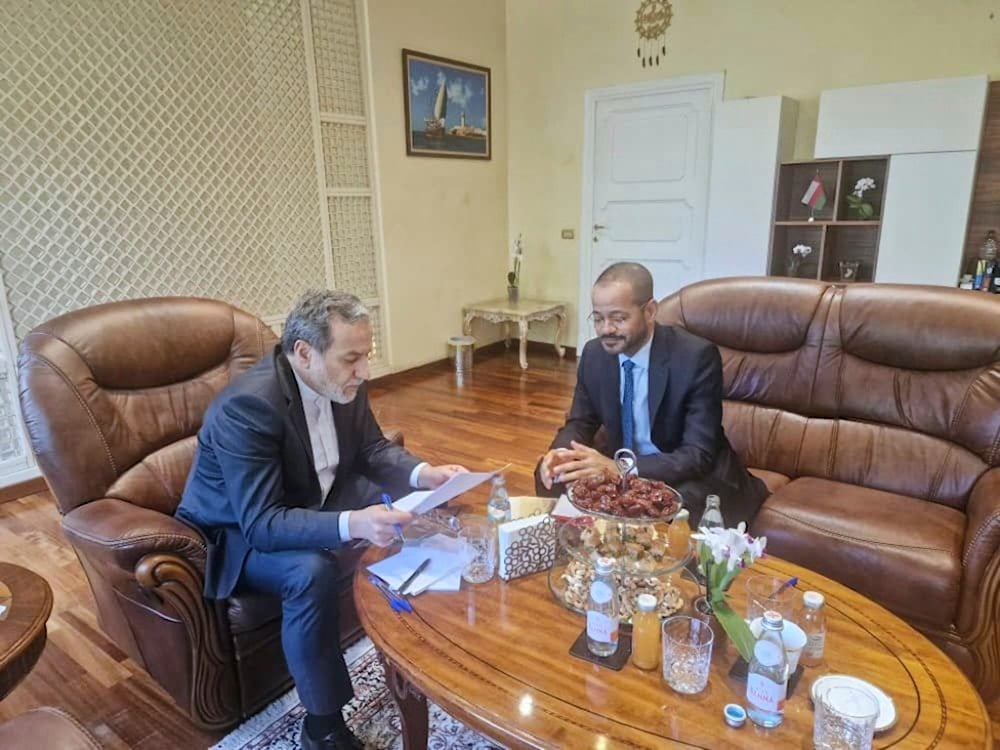 Iranian Foreign Minister Abbas Araghchi, left, reads a paper in a meeting with his Omani counterpart Sayyid Badr Albusaidi at the Omani Embassy in Rome during the fifth round of Iran-US negotiations, Friday, May 23, 2025 (Iran Foreign Ministry)