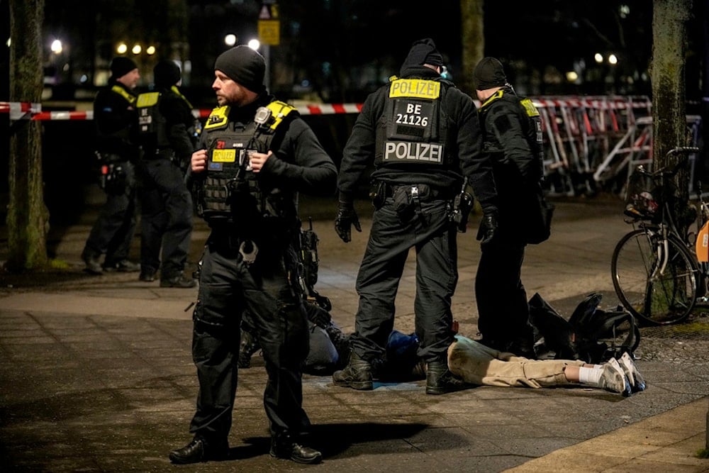 Police officers detain a man in Berlin, Germany, after another man was seriously injured, Friday, Feb. 21, 2025 (AP)