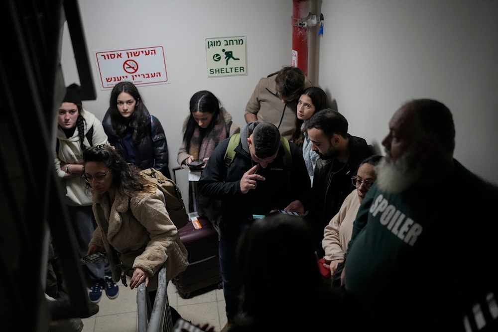 Israelis gather in a shelter after airstrike sirens sounded off in Ben Gurion Airport, near Tel Aviv, “Israel”, early Friday, Jan. 3, 2024. (AP )