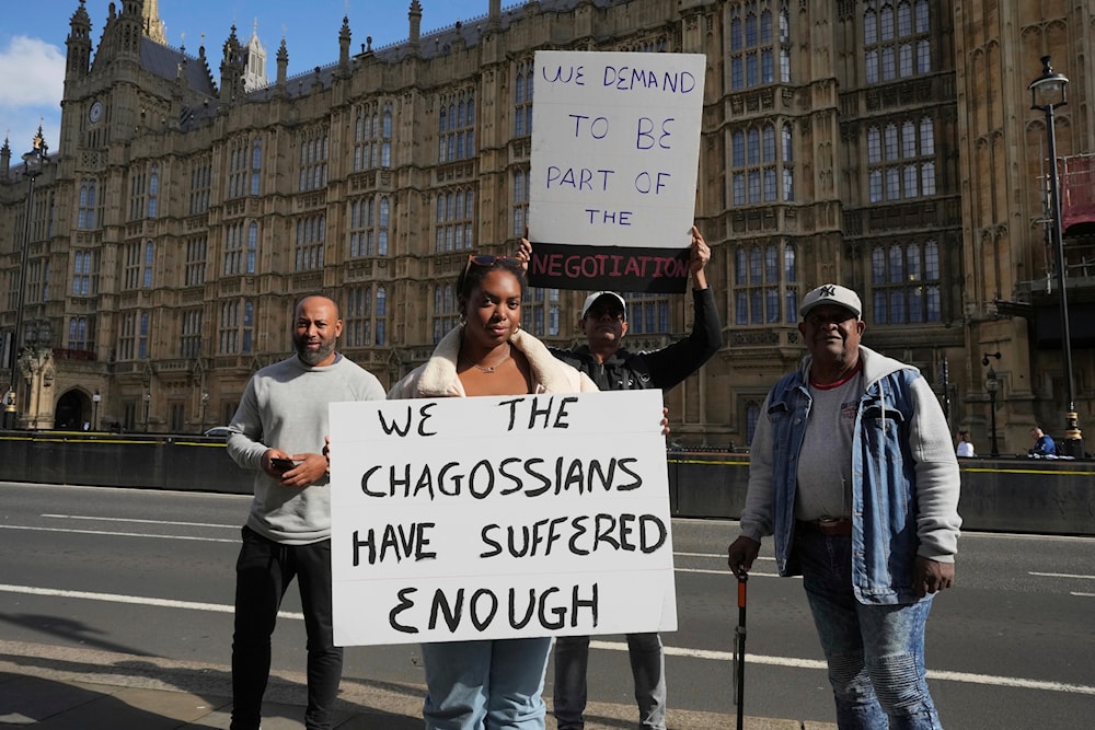 Chagossians Whitney Tranquille, center, attends a protest outside the House of Parliament, in London, Oct. 7, 2024. (AP)