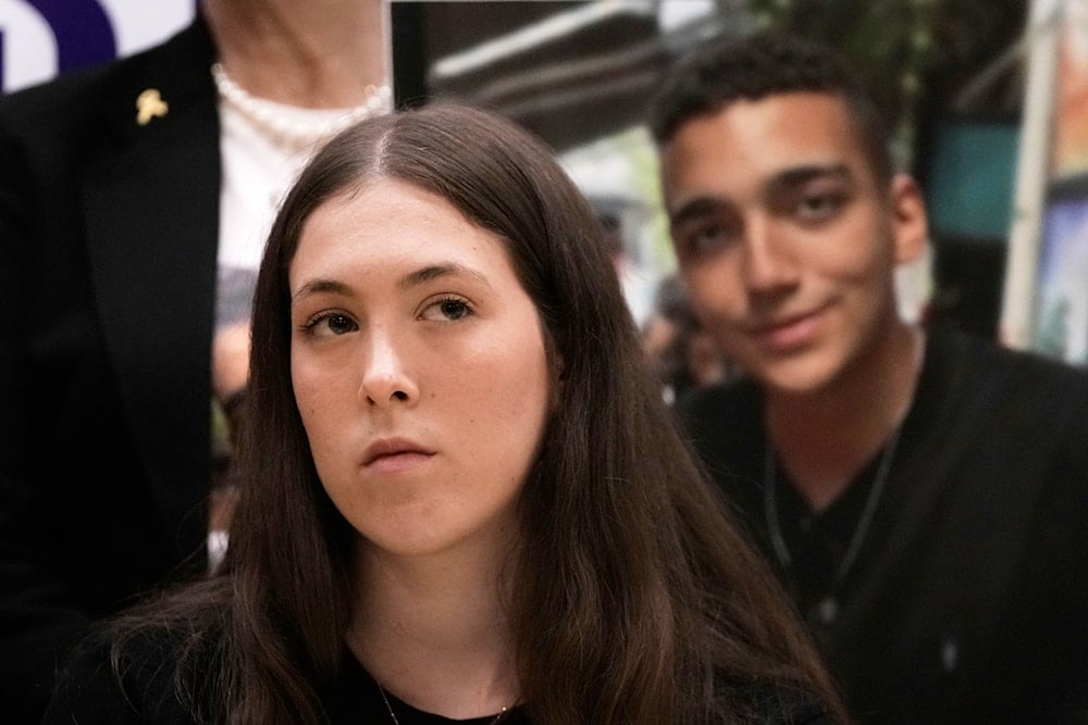 Freed Israeli captive Naama Levy listens to a statement to journalists marking 100 days of US President Donald Trump's Presidency in Tel Aviv,Monday, April 28, 2025. (AP)