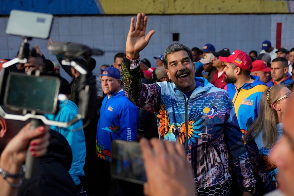 Venezuelan President Nicolas Maduro, center, gestures to supporters during a closing campaign rally for the regional election on May 25, in Caracas, Venezuela, Thursday, May 22, 2025 (AP)