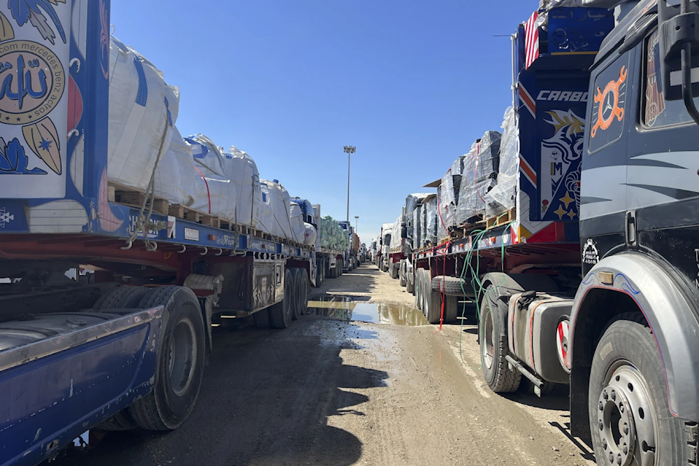 Trucks line up at the Egyptian side of the Rafah border crossing between Egypt and the Gaza Strip, March 2, 2025 (AP/Mohamed Arafat)