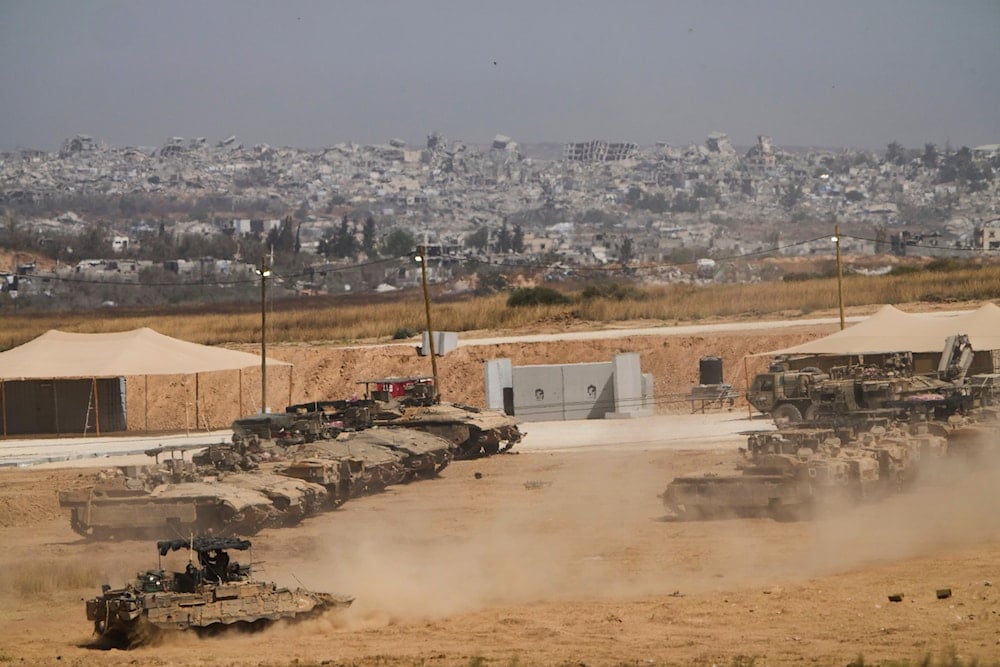 Israeli soldiers work on tanks and armored vehicles at a staging area near the border with the Gaza Strip, Occupied Palestine, Monday, May 26, 2025 (AP)