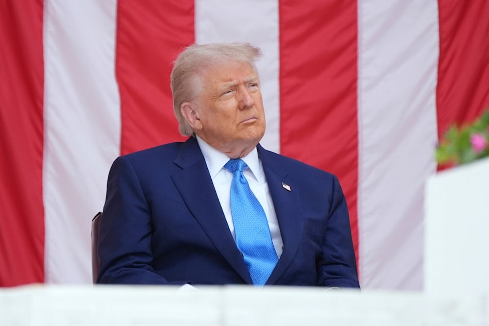 President Donald Trump listens during the 157th National Memorial Day Observance at Arlington National Cemetery, Monday, May 26, 2025, in Arlington, Va (AP)