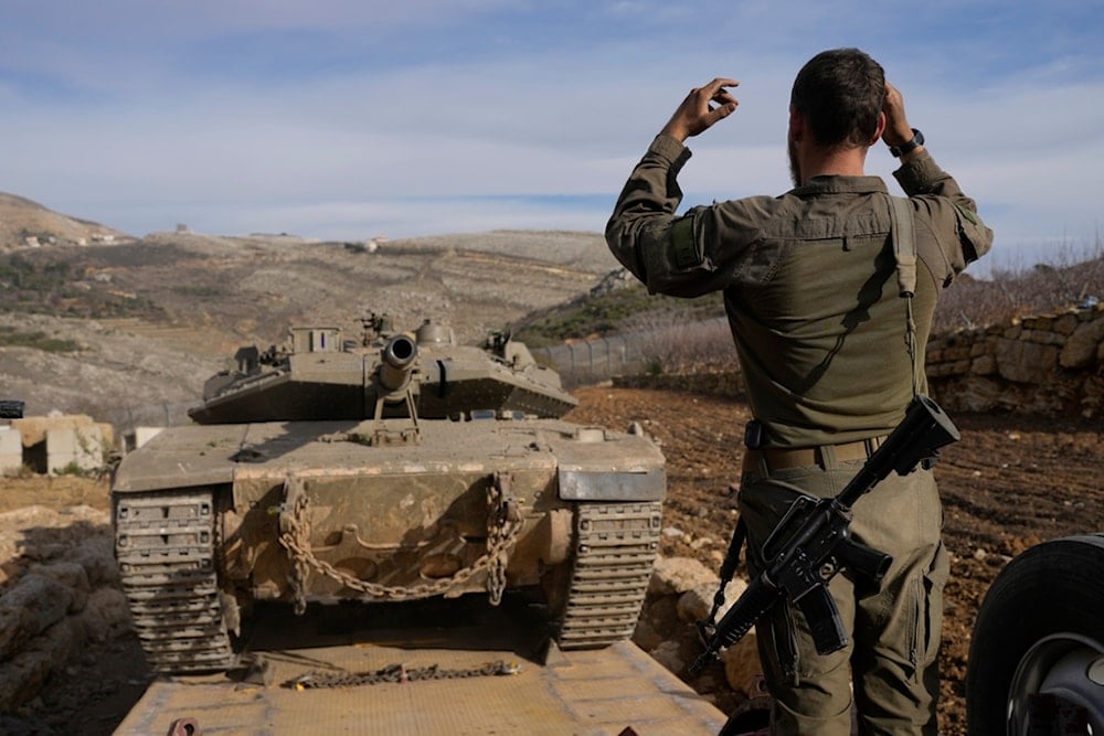 An Israeli soldier loads a tank near the so-called Alpha Line seoerating the Israeli-occupied Golan Heights from the rest of Syria, in the town of Majdal Shams, Dec. 11, 2024 (AP)