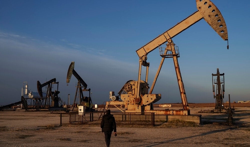 A worker walks past idle pumpjacks at an oil field on the outskirts of the northeastern Syrian city of Qamishli, Monday, Feb. 3, 2025.(AP)
