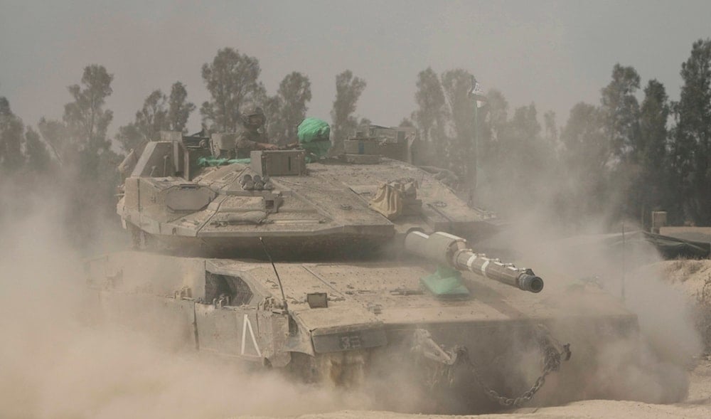 Israeli soldiers move tanks around staging area near the border with the Gaza Strip, in southern occupied Palestine, Sunday, May 18, 2025. (AP)