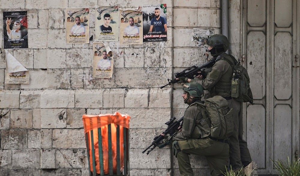 Israeli occupation soldiers take position during a raid in the West Bank city of Nablus, Tuesday, May 27, 2025. (AP)