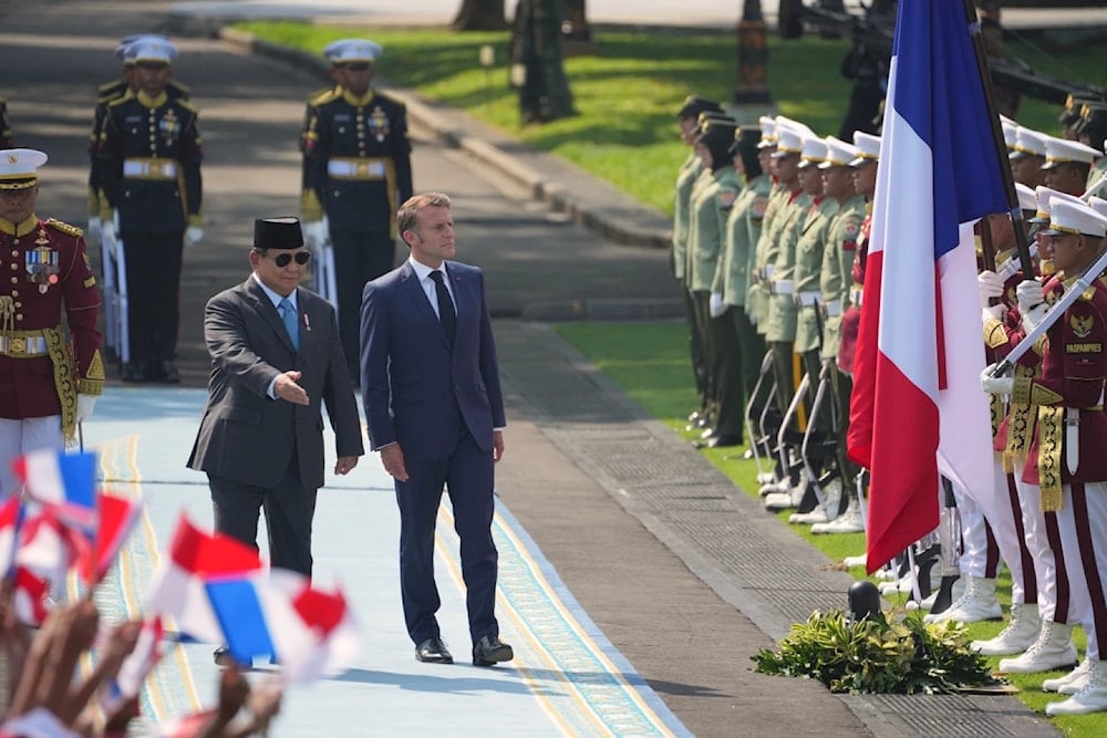 French President Emmanuel Macron, center right, and Indonesian President Prabowo Subianto, center left, inspect honor guards before their meeting at Merdeka Palace in Jakarta, Indonesia, May 28, 2025 (AP/Achmad Ibrahim)