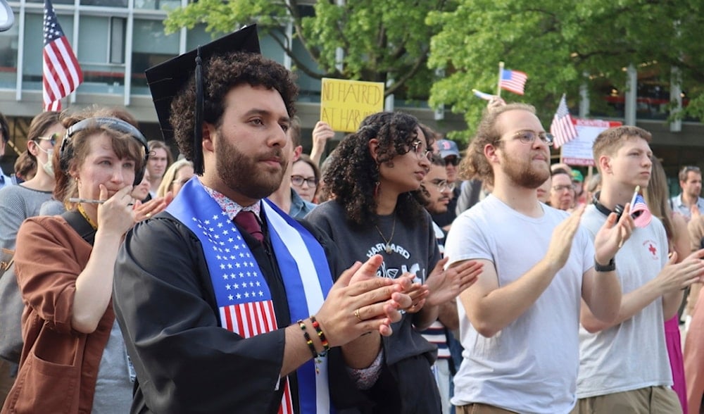 Harvard graduating senior Victor Flores claps while listening to a fellow student speak at a protest against Trump's recent sanctions against Harvard in front of Science Center Plaza, May 27, 2025, in Cambridge, Mass. (AP)