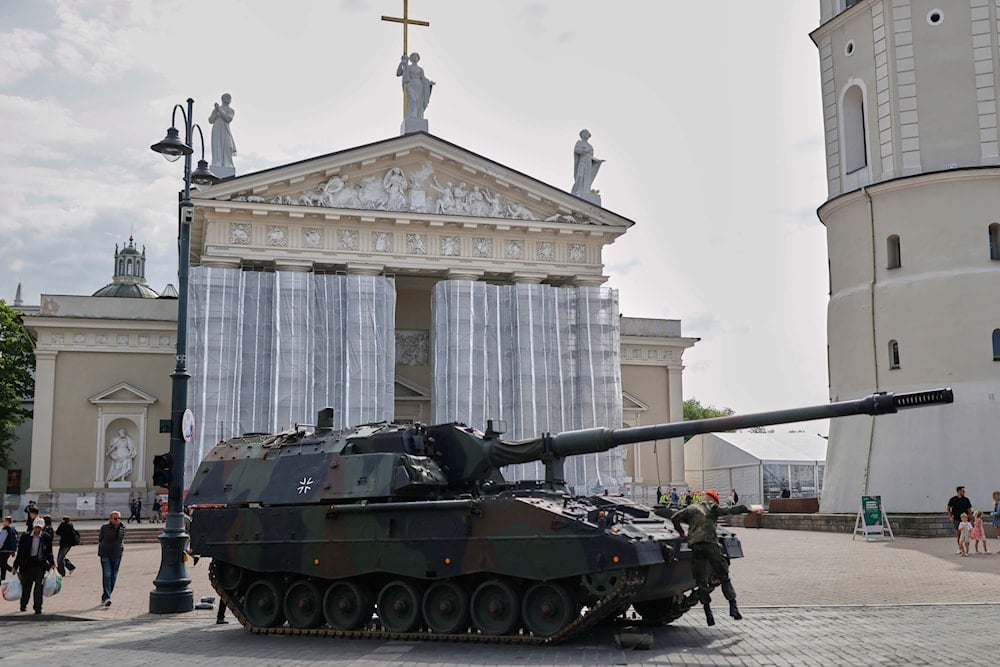 A German tank stands in front of the cathedral before the formal inauguration of a German brigade for NATO's eastern flank in the center of Vilnius, Lithuania, on May 22, 2025. (AP Photo/Mindaugas Kulbis)
