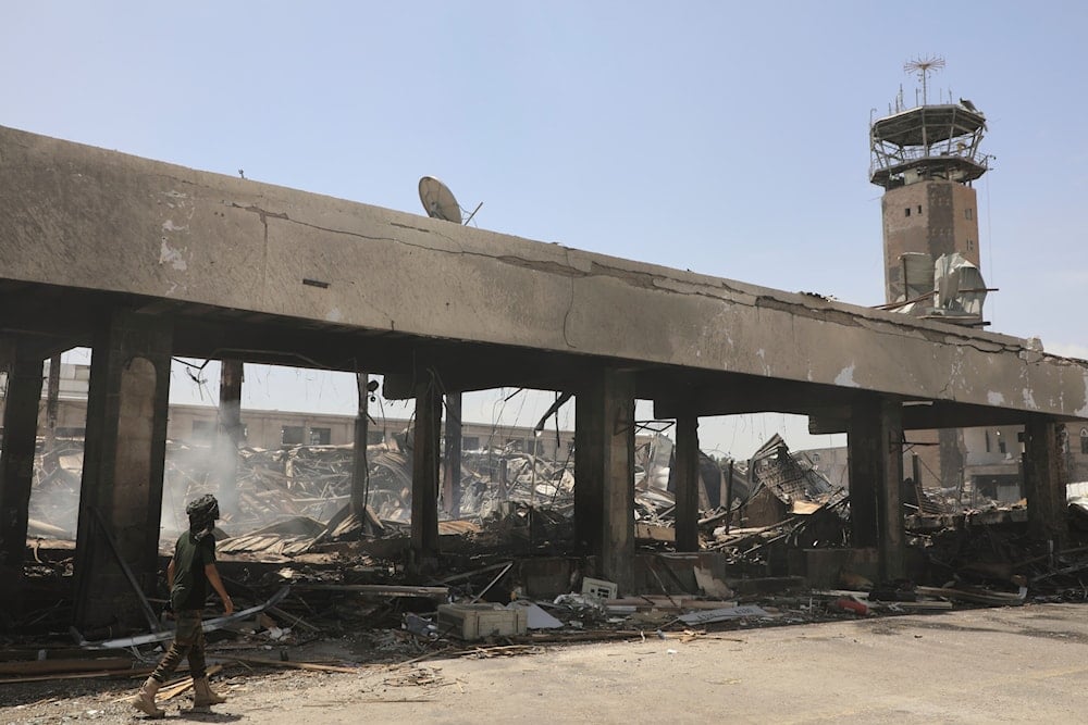 A Yemeni officer inspects the damage following Israeli airstrikes on Sanaa International Airport in Sanaa, Yemen, on May 7, 2025. (AP Photo/Osamah Abdulrahman)
