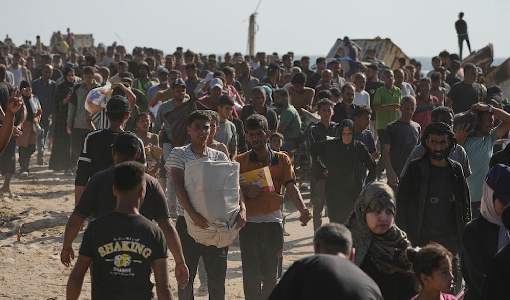 Palestinians carry boxes containing food and humanitarian aid packages delivered by the Gaza Humanitarian Foundation in Rafah, southern Gaza Strip, on Tuesday, May 27, 2025. (AP)