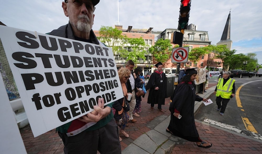 Students cross into Harvard yard passing protesters as Harvard University holds its commencement, Thursday, May 29, 2025 in Cambridge, Mass. (AP)