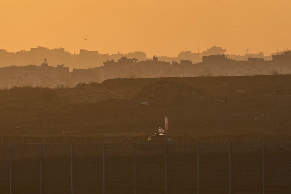 An Israeli army vehicle moves in the Gaza Strip as seen from southern occupied Palestine, Thursday, May 29, 2025 (AP)