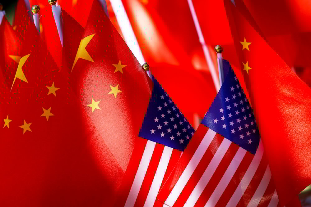 US flags are displayed together with Chinese flags on top of a trishaw on Sept. 16, 2018, in Beijing. (AP)