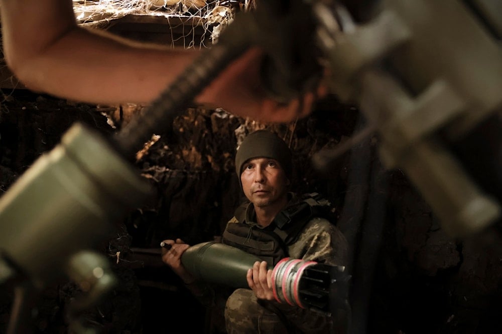 In this photo taken on May 27, 2025 and provided by Ukraine's 24th Mechanized Brigade press service, a soldier fires a 120mm mortar towards Russian army positions near Chasiv Yar, Donetsk region, Ukraine, Tuesday, May 27, 2025 (AP)