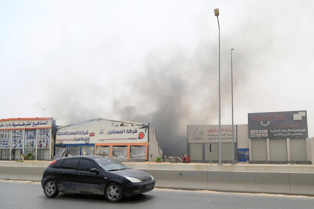 Smoke fills the sky near the site of clashes between heavily armed militias in Tripoli, Libya, Wednesday, May 14, 2025 (AP)