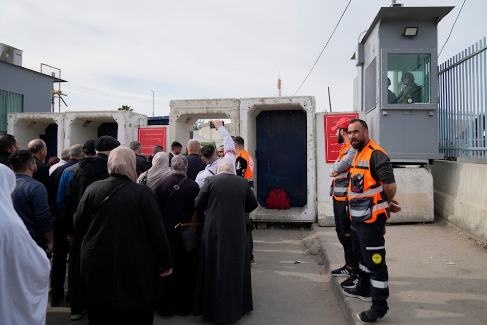 Palestinians cross from the Israeli military Qalandia checkpoint near the West Bank city of Ramallah to occupied al-Quds on Friday, March 14, 2025 (AP)