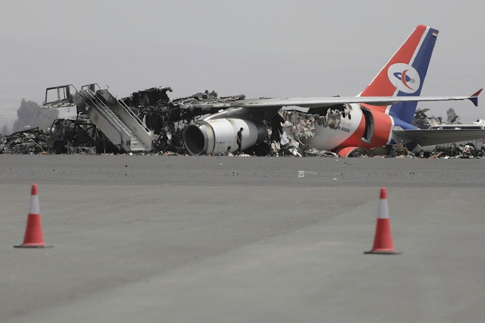 A man walks in front of a damaged Yemeni plane at Sanaa International Airport in Sanaa, Yemen, Thursday, May 29, 2025, a day after Israeli airstrikes (AP)