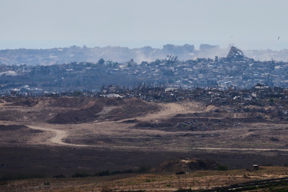 Destroyed buildings in the Gaza Strip as seen from the separation line with Gaza, Thursday, May 29, 2025. (AP Photo/Ohad Zwigenberg)
