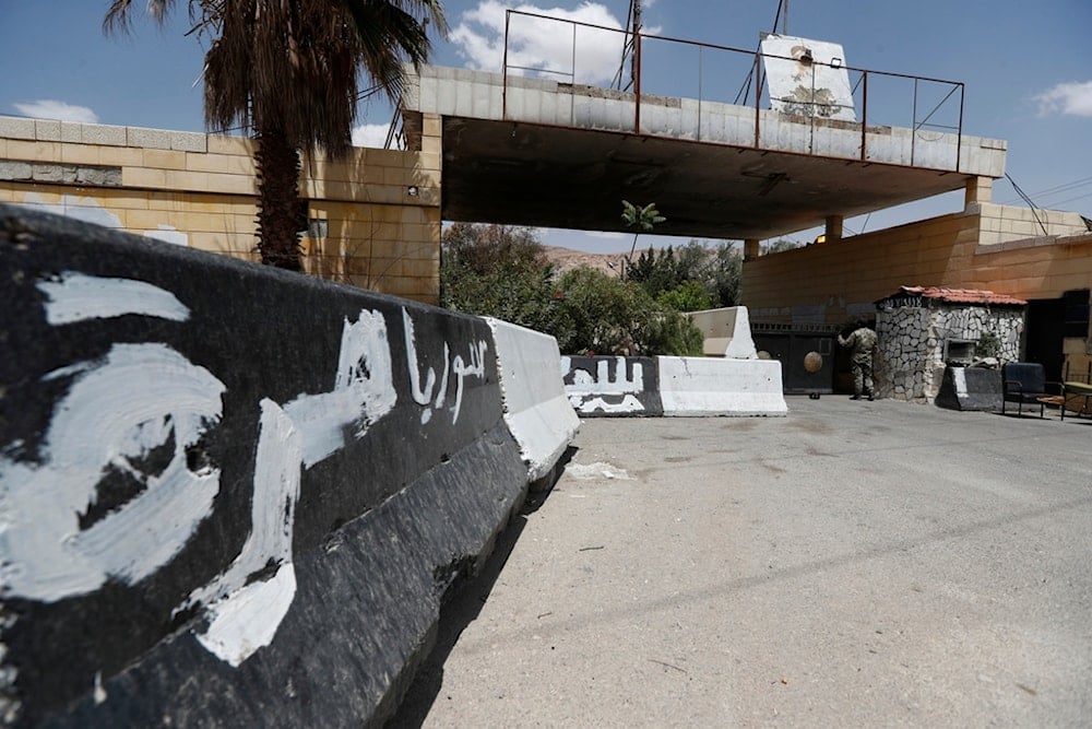 A Syrian soldier stands at the gate of a military base on the outskirts of Harasta, near Damascus, Syria, Saturday, May 3, 2025. (AP Photo/Omar Sanadiki)