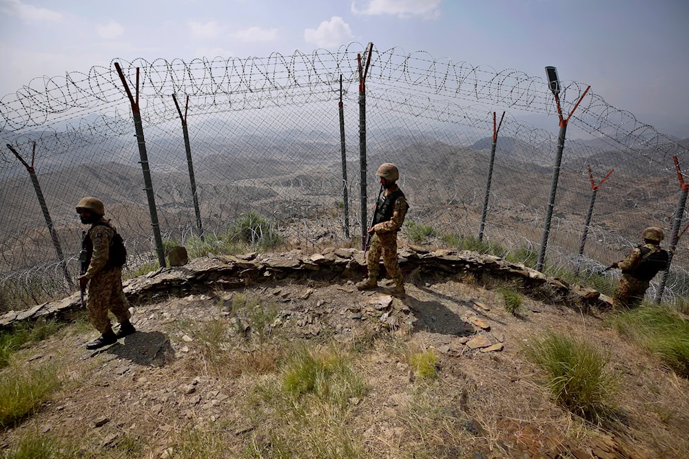 Pakistan Army troops patrol along the fence on the Pakistan Afghanistan border at Big Ben hilltop post in Khyber district, Pakistan, Aug. 3, 2021. (AP)