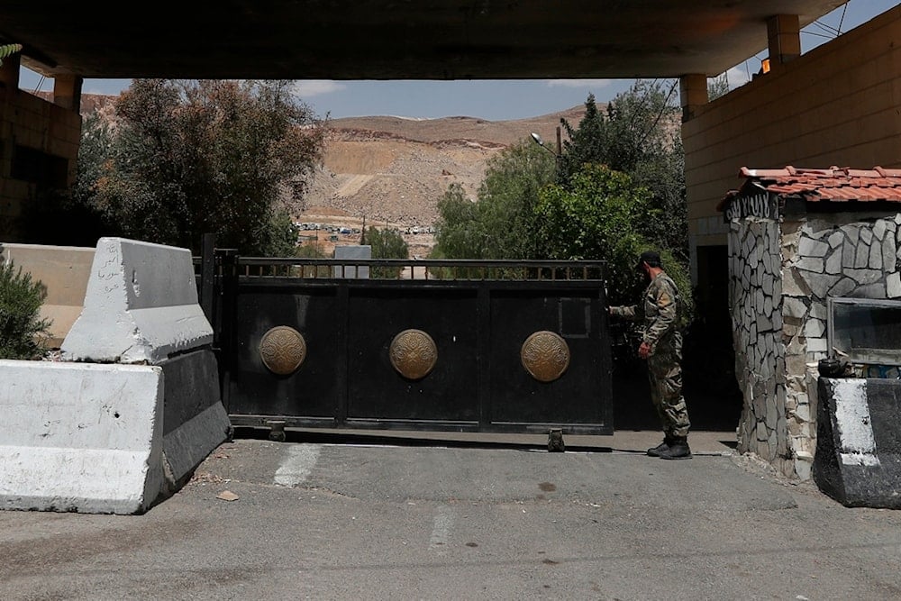 A Syrian soldier closes the gate of a military base on the outskirts of Harasta, near Damascus, Syria, Saturday, May 3, 2025 (AP)