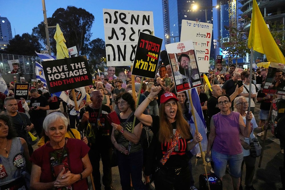 People take part in a protest demanding the end of the war and immediate release of hostages held by Hamas in the Gaza Strip, and against Prime Minister Benjamin Netanyahu's government, in Tel Aviv, on May 31, 2025. (AP Photo/Ariel Schalit)