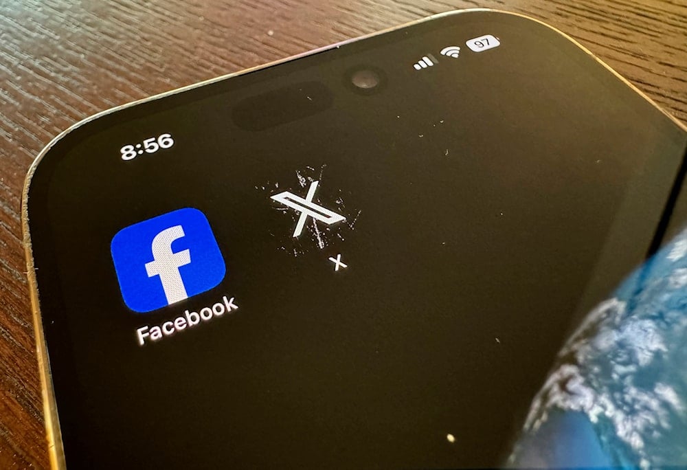 App logos for Facebook, left, and X, formerly known as Twitter, are seen on a mobile phone in Los Angeles, Saturday, March 16, 2024 (AP)