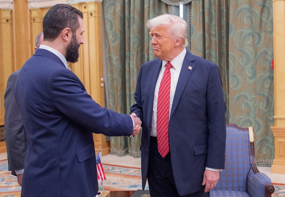 In this photo released by the Saudi Royal Palace, President Donald Trump, right, shakes hands with Syria's interim President Ahmad al-Sharaa, in Riyadh, Saudi Arabia, on May 14, 2025. (Bandar Aljaloud/Saudi Royal Palace via AP)