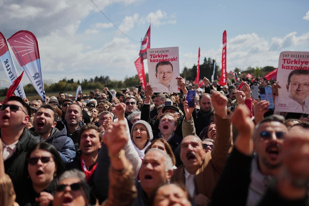 Supporters chant slogans as they gather outside Silivri Prison, where a hearing is taking place for Istanbul Mayor Ekrem Imamoglu in one of multiple cases against him, west of Istanbul, Turkey, on April 11, 2025. (AP Photo/Francisco Seco)