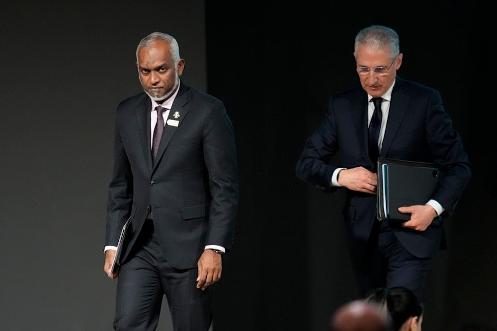 Maldives President Mohamed Muizzu, left, walks next to Mukhtar Babayev, COP29 President, at a summit of the leaders of Small Islands Developing States during the COP29 UN Climate Summit, Wednesday, November 13, 2024, in Baku, Azerbaijan (AP)