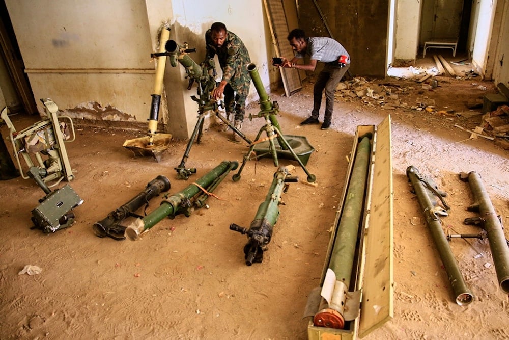 Sudanese army officers inspect a recently discovered weapons storage site belonging to the paramilitary Rapid Support Forces (RSF) in Khartoum, Sudan, Saturday, May 3, 2025 (AP)