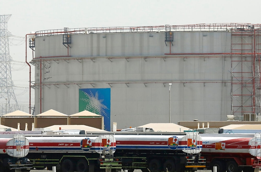  Fuel trucks line up in front of storage tanks at the North Jiddah bulk plant, an Aramco oil facility, in Jiddah, Saudi Arabia, on March 21, 2021. (AP)