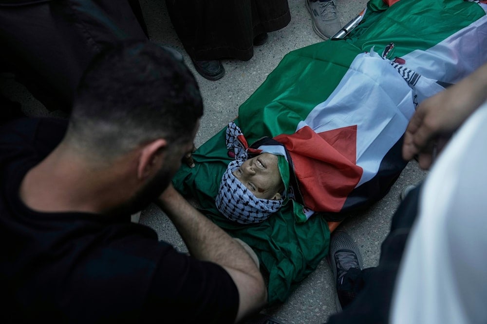 A relative mourns over the body of Abdul Khaleq Jbour, 16, who was killed in an Israeli raid, during his funeral at the West Bank village of Salem, near Nablus, Friday, April 25, 2025. (AP )