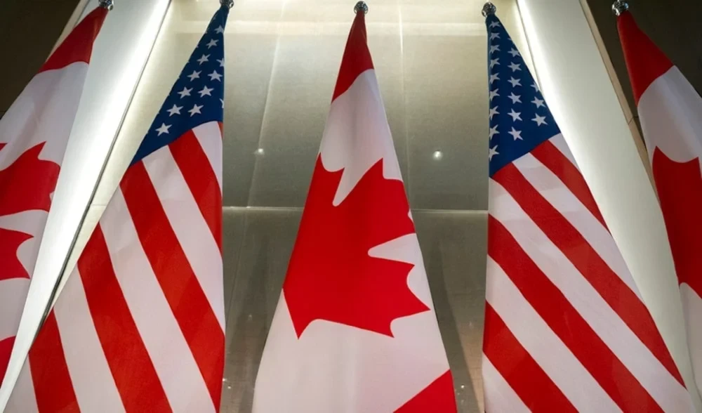 US and Canada flags are displayed before an event with Ontario Premier Doug Ford and the US Chamber of Commerce, February 11, 2025, Washington (AP)