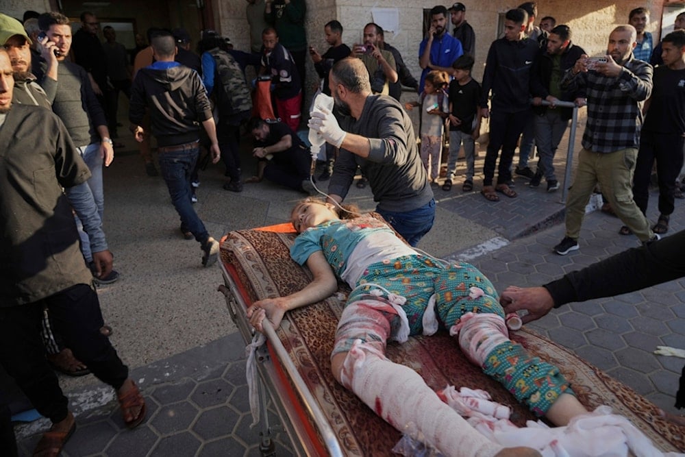 A Palestinian girl wounded in an Israeli airstrike on a school in Bureij refugee camp is brought to Al-Aqsa Martyrs Hospital in Deir al Balah, central Gaza Strip, on May 6, 2025. (AP)