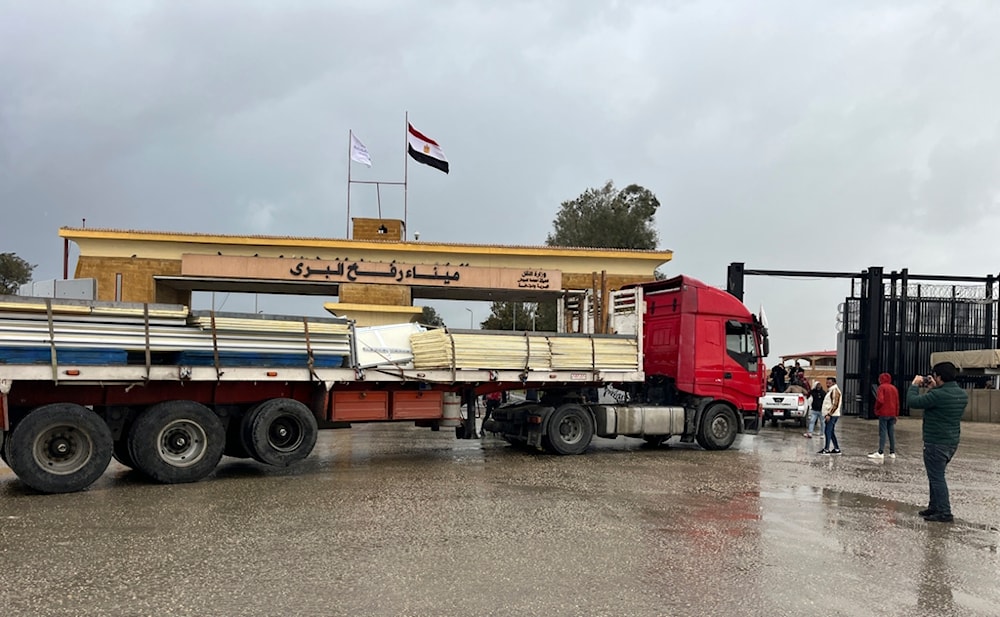 A truck carrying mobile homes crosses the Egyptian side of the Rafah crossing, in preparation for entering Gaza, Thursday, Feb. 20, 2025 (AP)