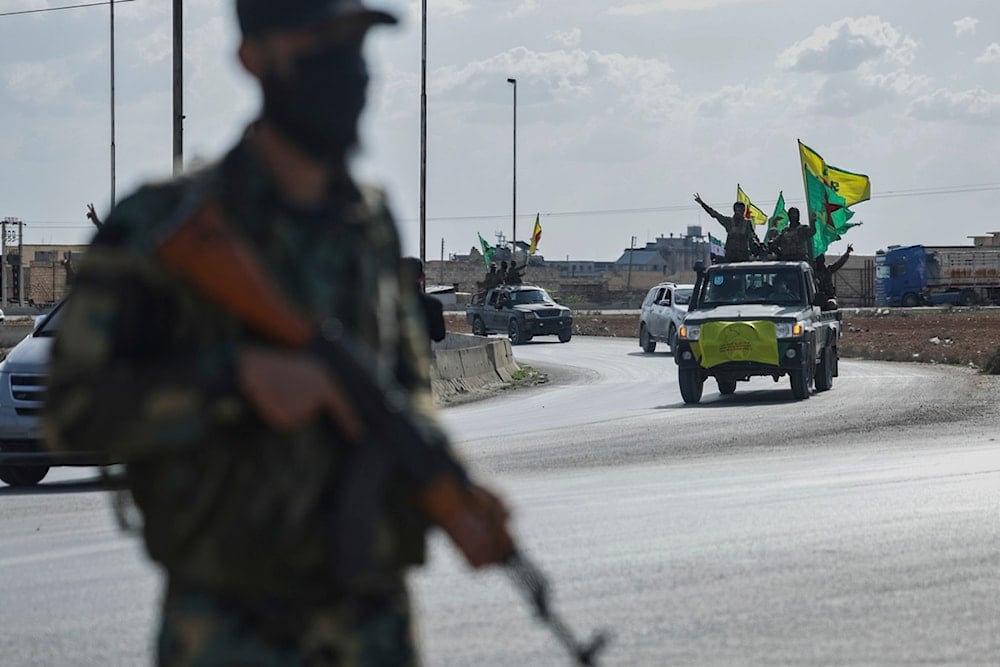 US-backed Kurdish fighters stand on their vehicles, as they withdraw from two neighborhoods in Syria's northern city of Aleppo as part of a deal with the Syrian central government, in Aleppo, Syria, Friday, April 4, 2025 (AP)