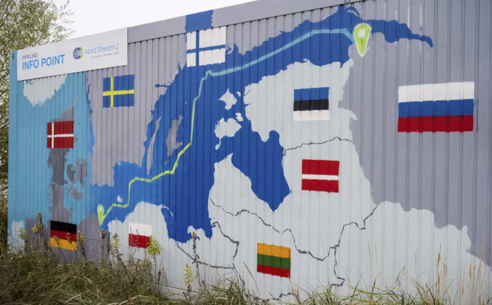 A sign reading 'Nord Stream 2 Committed. Reliable. Safe' hangs above a painted map at the natural gas receiving station in the Lubmin industrial estate in Lubmin, Germany in an undated photo (AP)