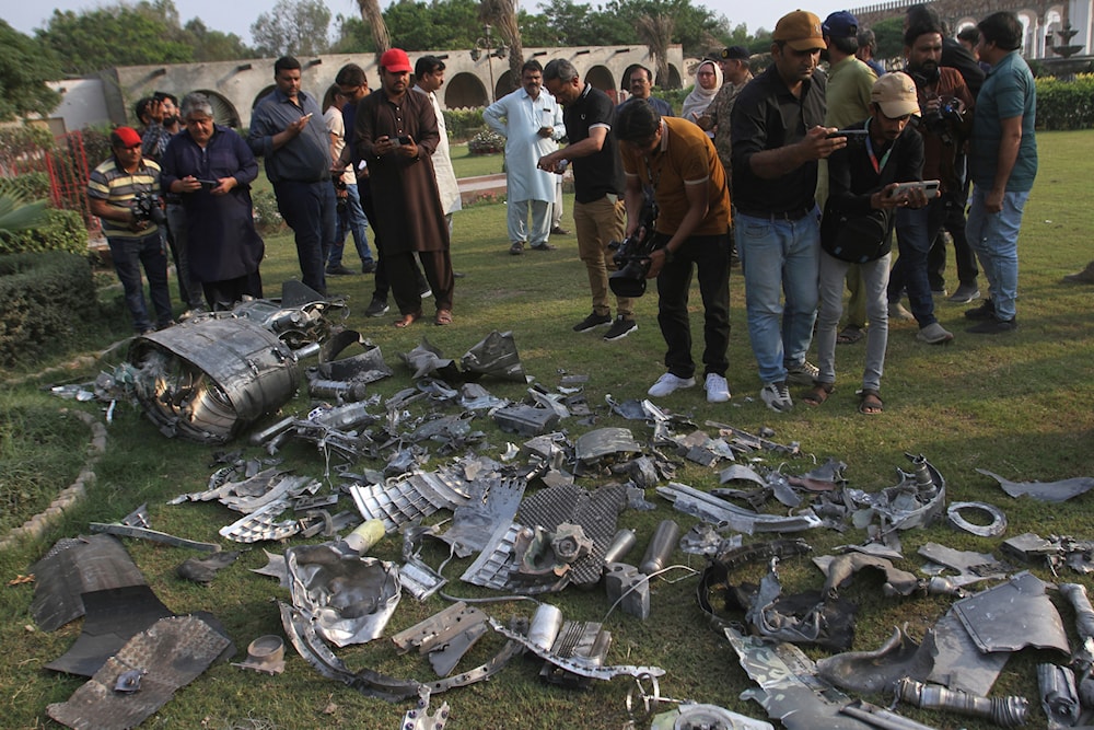 Members of the media film metal pieces of Indian missiles lie on the compound of a mosque building damaged by Indian missile attack, near Bahawalpur, a city in Pakistan's Punjab province, Wednesday, May 7, 2025. (AP)
