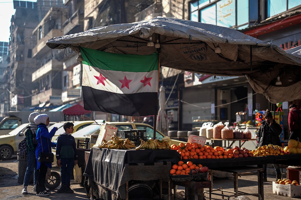 Children buy from a street vendor in an open market in Aleppo, Syria, on January 30, 2025. (AP Photo/Khalil Hamra)