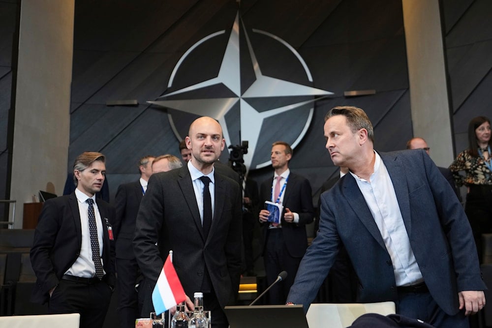 Luxembourg's Foreign Minister Xavier Bettel, right, speaks with French Foreign Minister Jean-Noel Barrot during a meeting of the North Atlantic Council at NATO headquarters in Brussels, Thursday, April 3, 2025 (A)