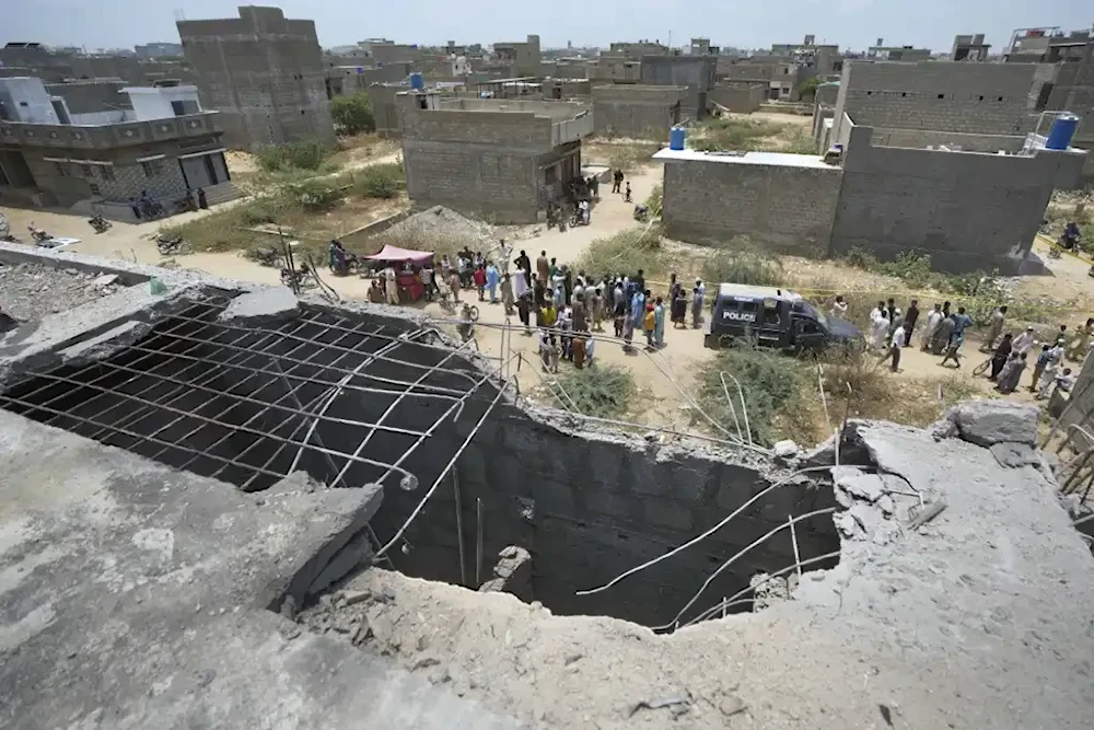A large hole is seen on a rooftop after a suspected Indian drone was shot down by Pakistan’s air defense in Karachi, May 8, 2025 (AP/Fareed Khan)