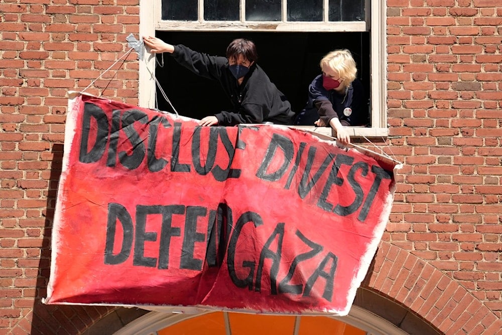 Activists hang a placard from a window of an upper floor of a building at Rhode Island School of Design, Tuesday, May 7, 2024, in Providence, Rhode Island, the United States (AP)
