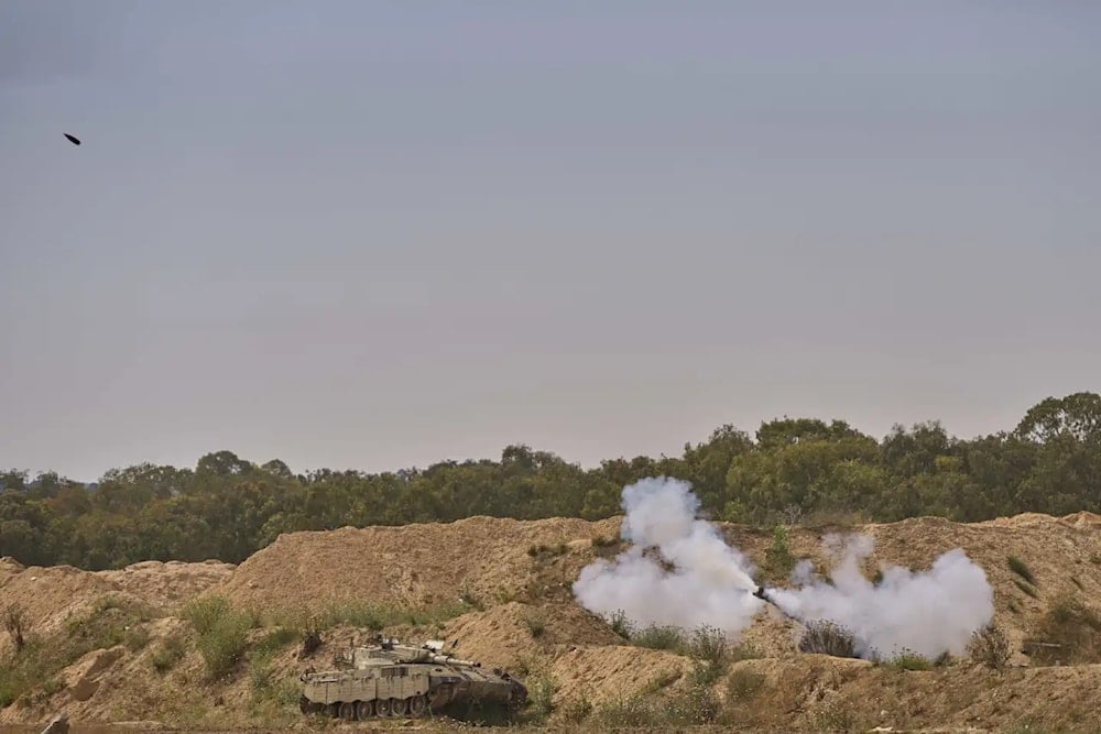 An Israeli mobile artillery unit fires a shell from the occupied Palestinian terriroties towards the Gaza strip, in a position near the 'Israel'-Gaza border on Tuesday May 6, 2025 (AP/Ohad Zwigenberg)