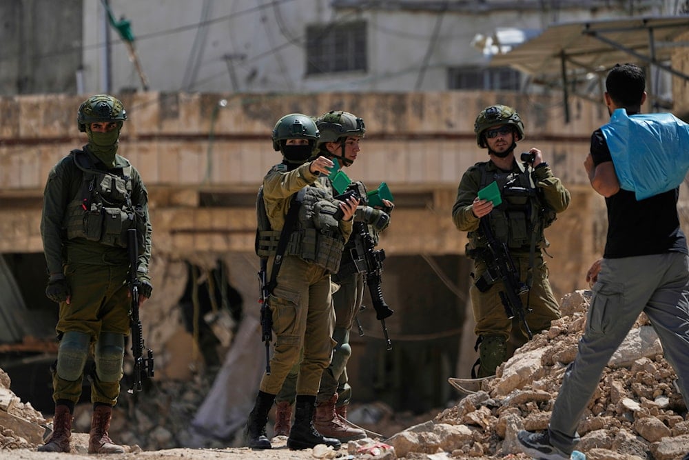 Israeli settlers, backed by occupation forces, assault Palestinians