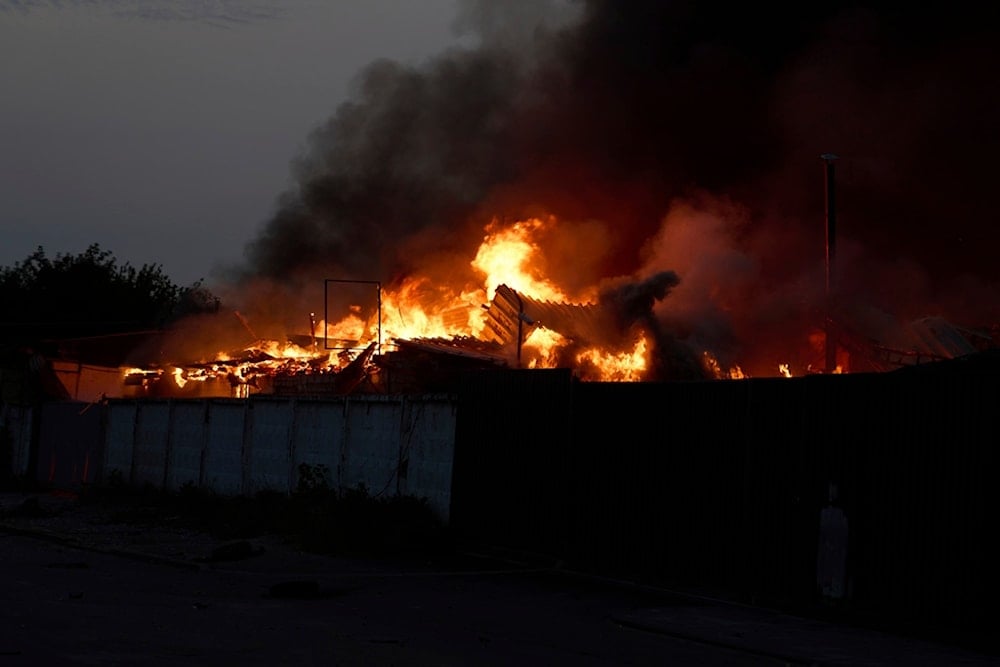 Black smoke and fire rise above the burning garages following Russia's massive missile and drone attack in Kiev, Ukraine, Tuesday, June 10, 2025 (AP)
